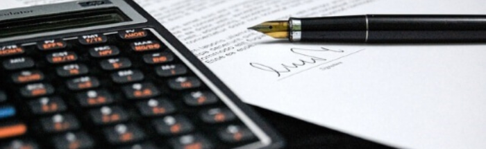 Taschenrechner und Stift auf Blatt