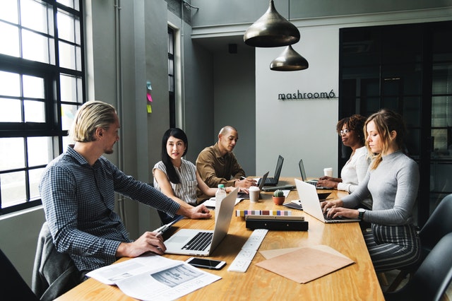 people in an agency talking about business