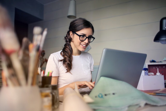 Woman smiling at laptop
